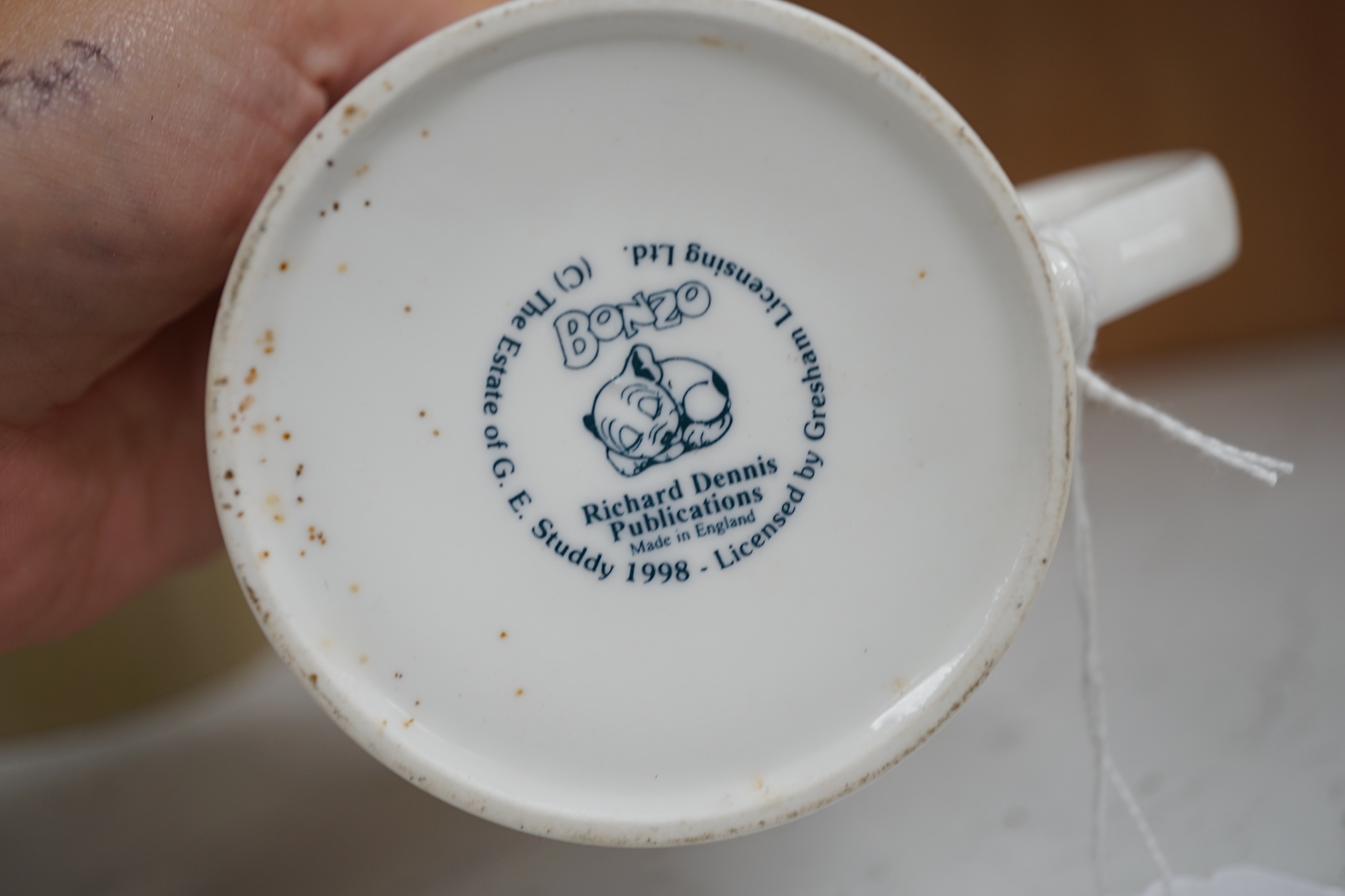 A Richard Dennis Bonzo Dog mug and matching plate and a Dennis China glazed pottery mug, plate 17cm diameter (3). Condition - slight chip to base edge of plate